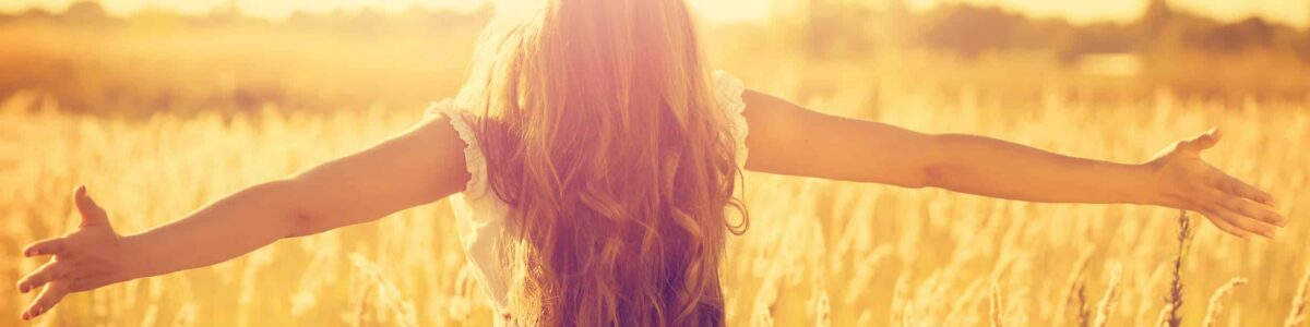 Woman with face raised up to the sun Woman with face raised up to the sun